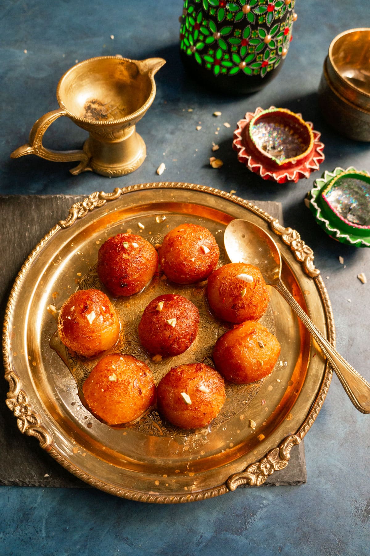 Gulab Jamun (Indian dessert balls) served in a pretty brass plate.