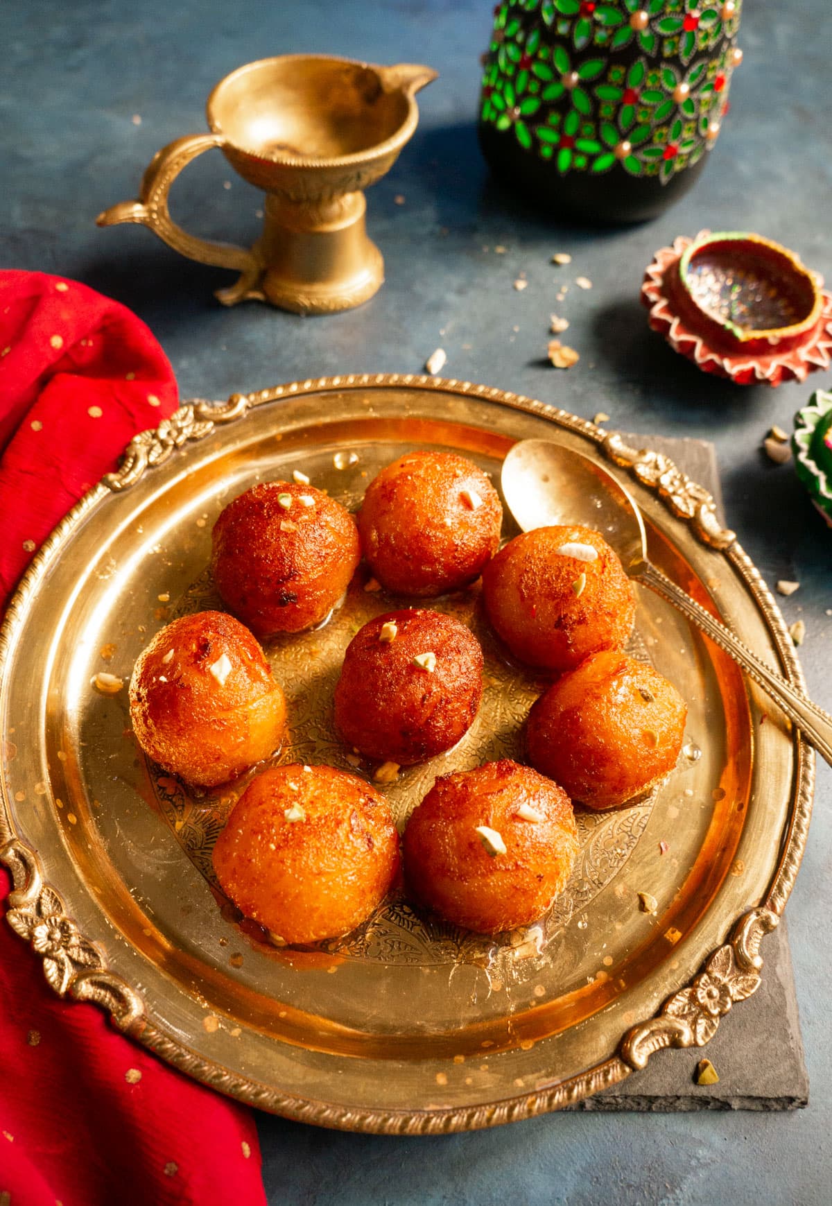 Gulab Jamun (Indian donuts) served in a pretty plate.