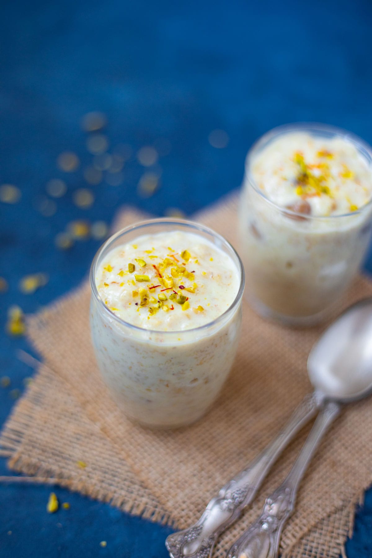 Oats Kheer (Indian oats recipe) garnished with saffron and pistachios.