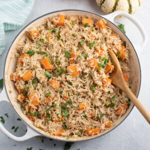 pumpkin rice in a large pan garnished with parsley