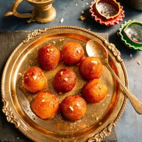 Gulab Jamun (Indian dessert balls) served in a pretty brass plate.
