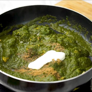 Add garam masala and cream to saag chicken