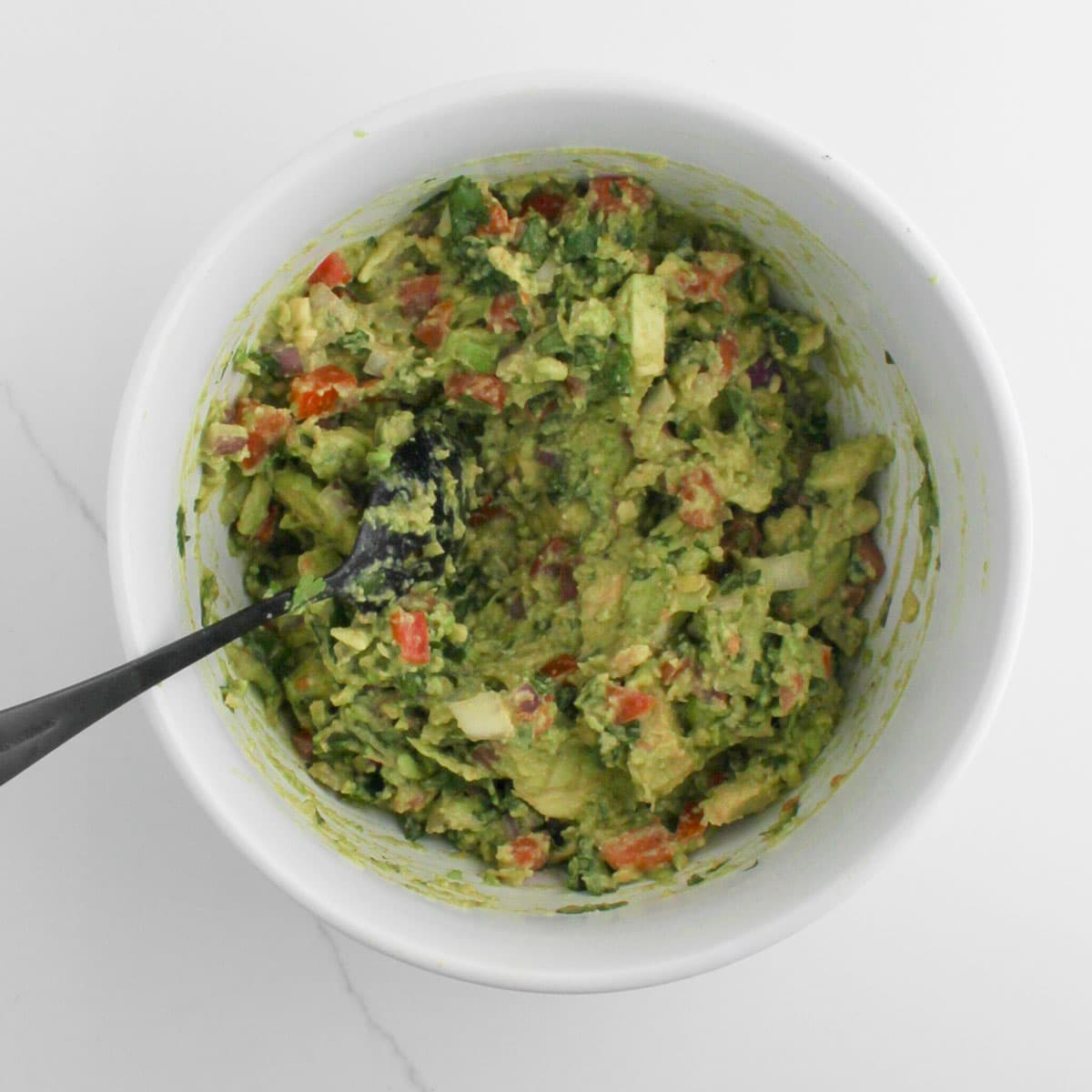 top view of Chunky Guacamole in a white bowl