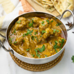Mughlai Chicken Zafrani served in a bowl garnished with cilantro leaves