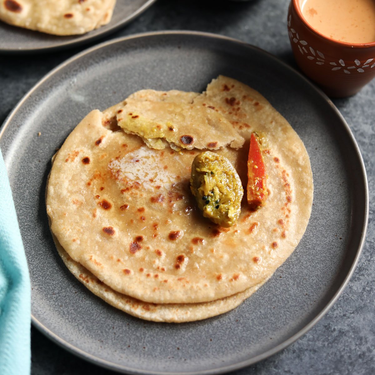 Paratha served with achar and chai