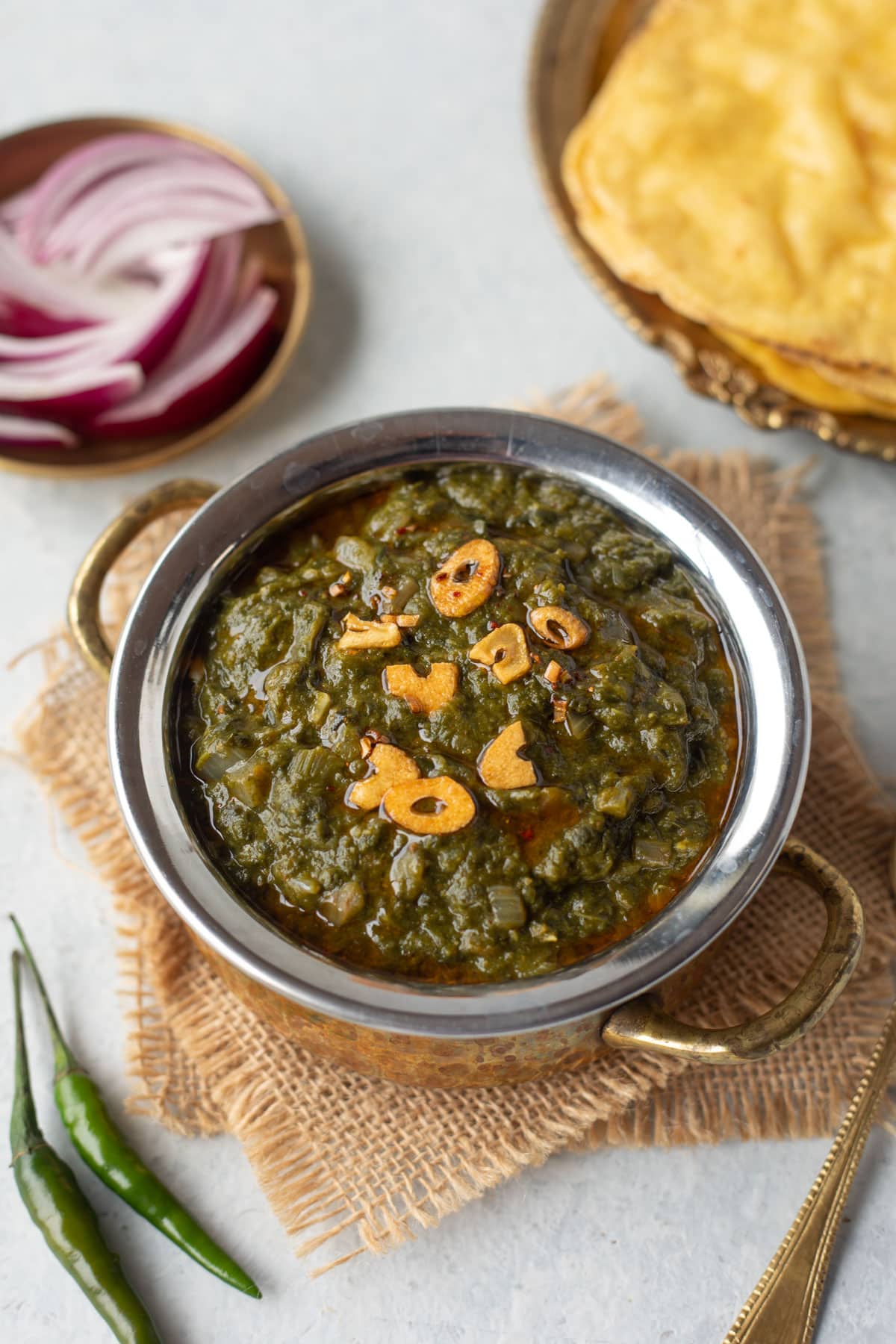 Sarson ka Saag served in a bowl topped with a garlic tempering.