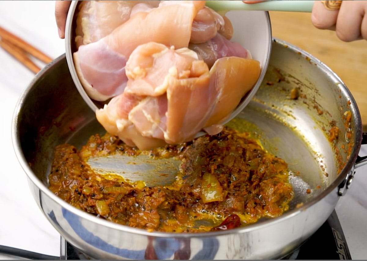 Adding chicken to the pan after spices are sauté for 3-4 minutes