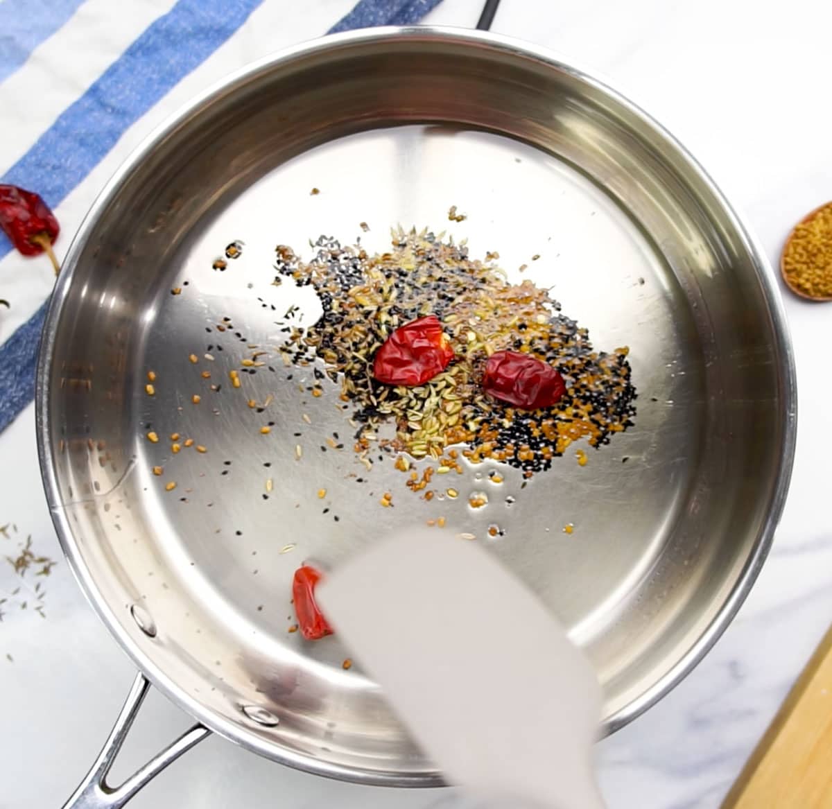 Cooking whole spices in the pan for about 30 seconds