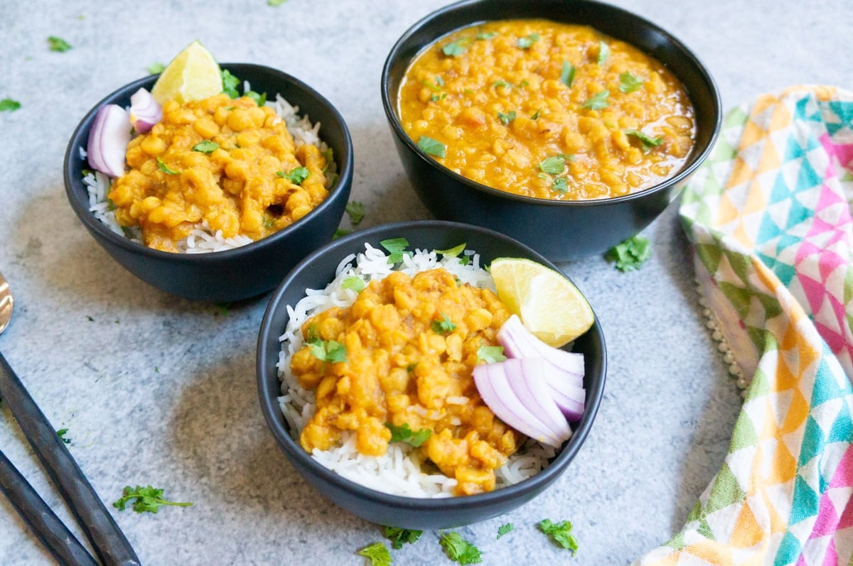 Chana dal served over rice in bowls. 