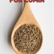 Cumin seeds in a wooden laddle