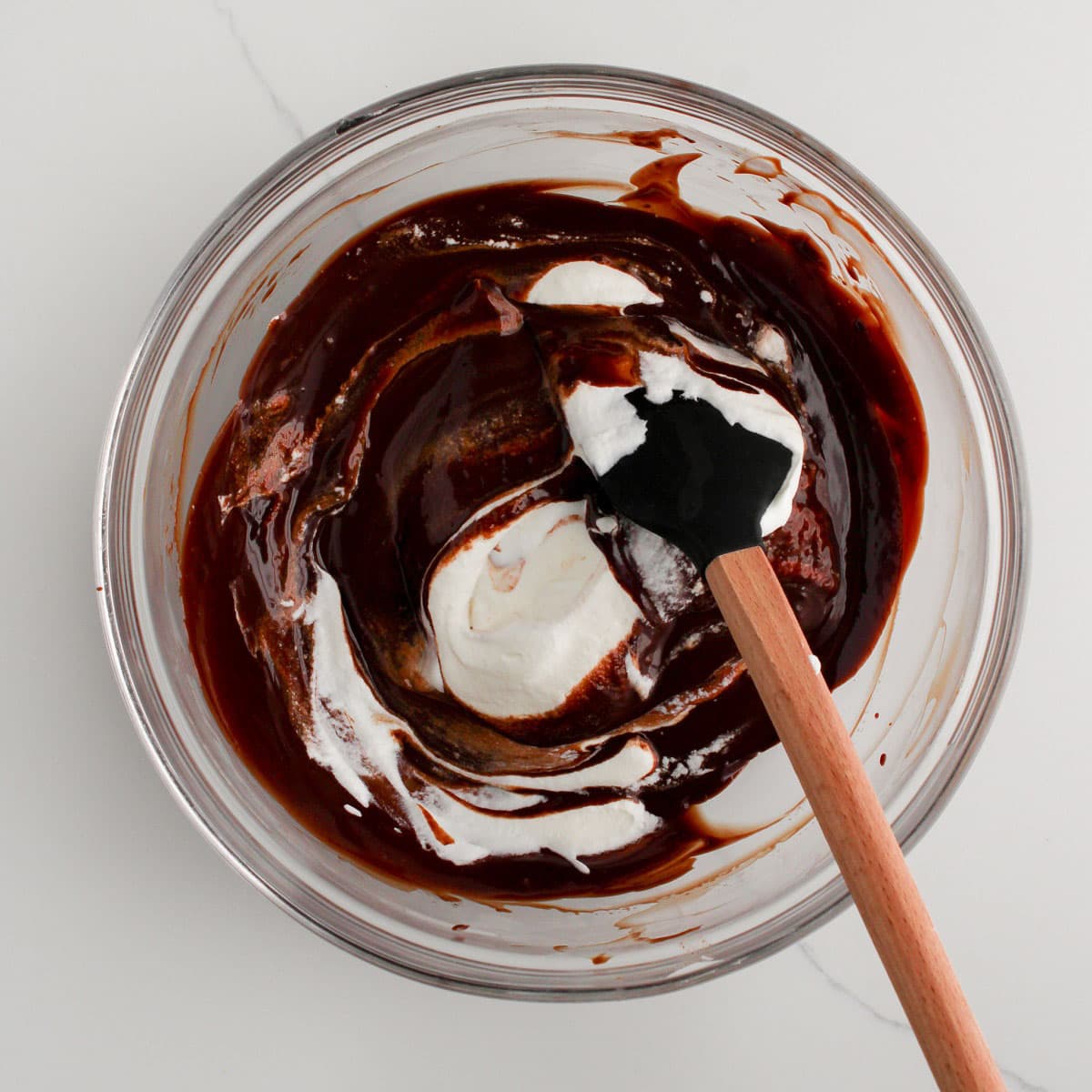 folding whipped cream into the melted chocolate