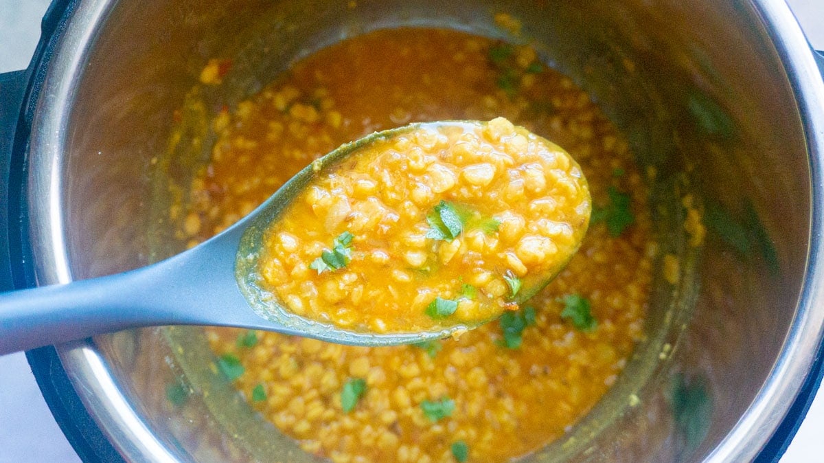Chana dal in a ladle over the instant pot