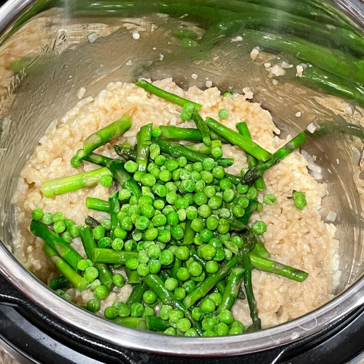 Asparagus and peas added to cooked arborio rice in the instant pot. 