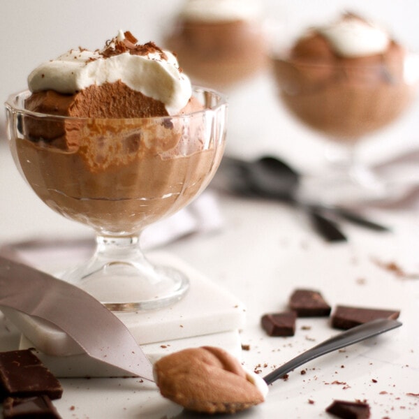 Chocolate mousse in a glass serving and in a spoon