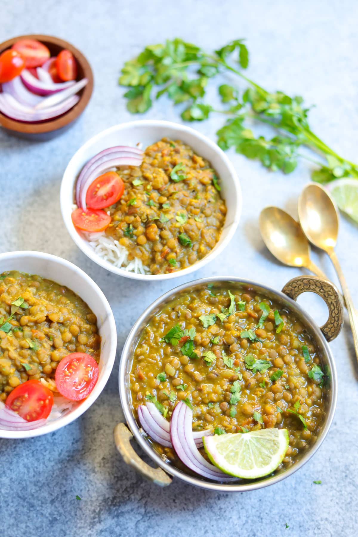 whole masoor dal in a small pot and in two bowls with rice