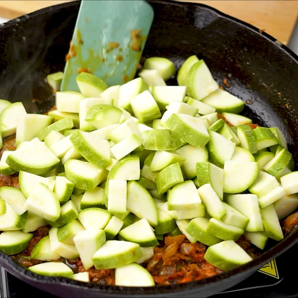 Adding sliced zucchini along with spices