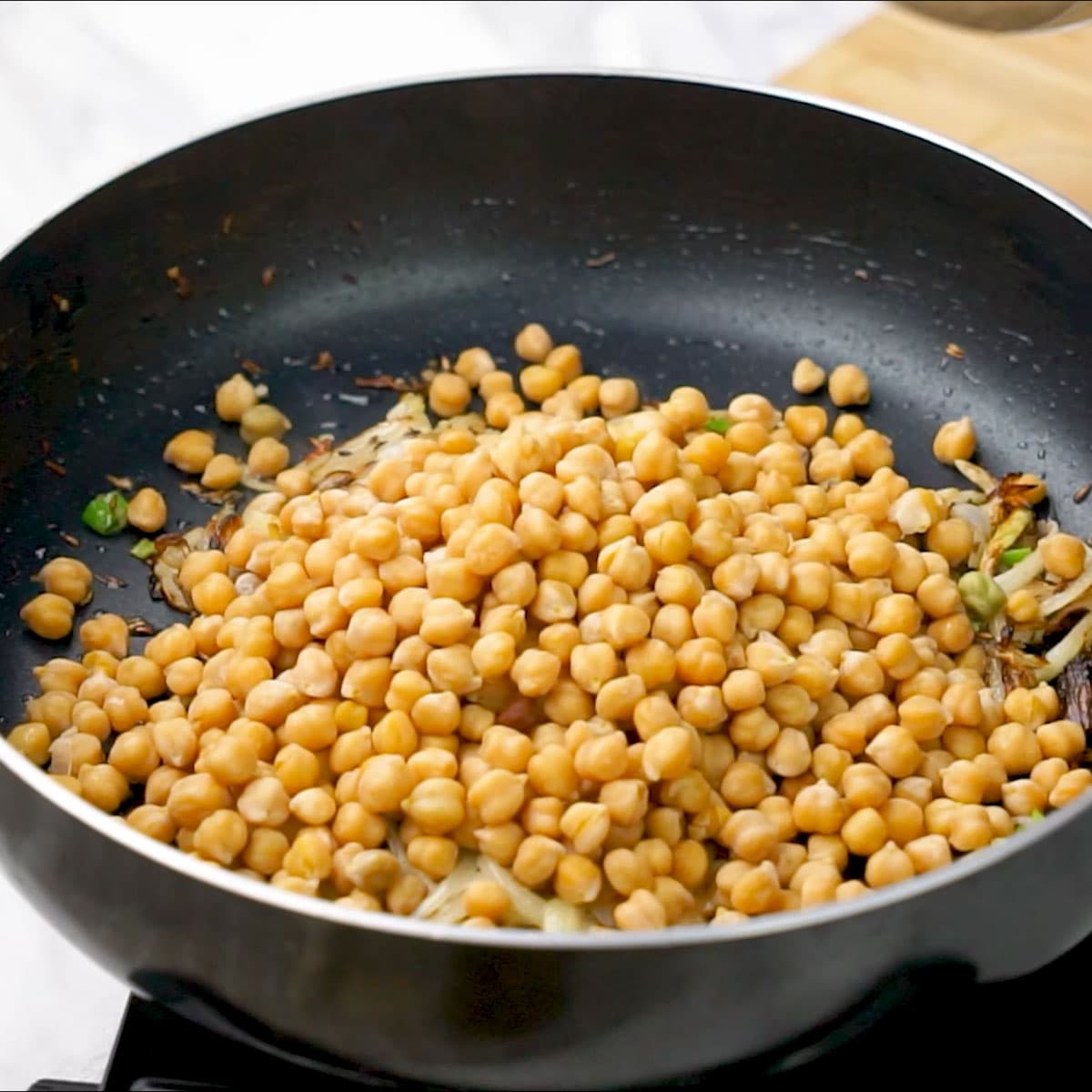 Adding boiled Chickpeas to the pan