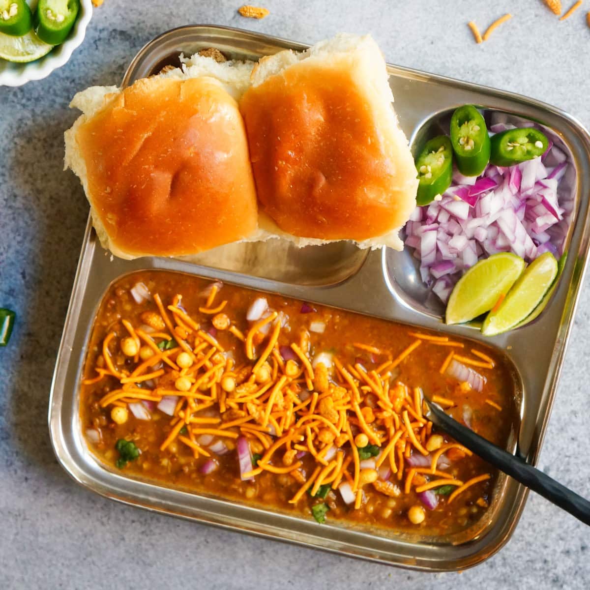 Misal pav served with onions and lime