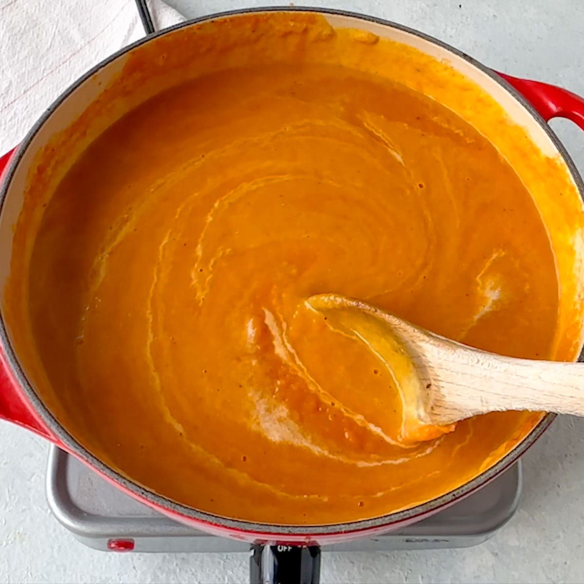 Pumpkin Carrot Soup in hot pan ready to serve just before garnishing