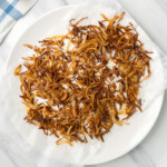 Crispy fried onions on a white plate