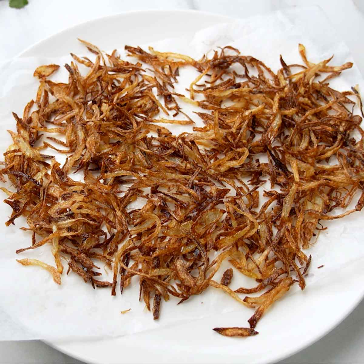 spread out fried onions to make them crispy