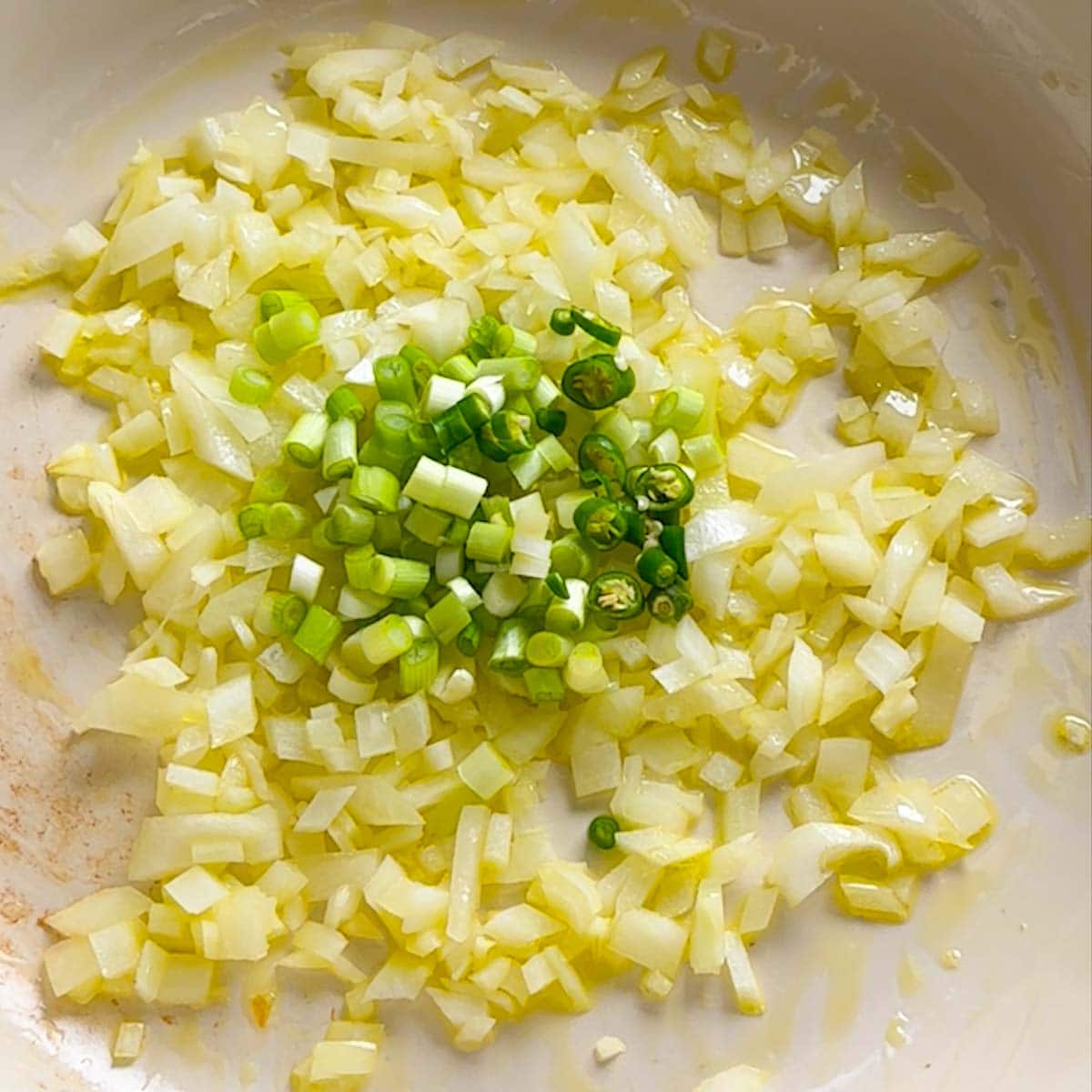 green onion and green chili added into the pan with sauteed onions