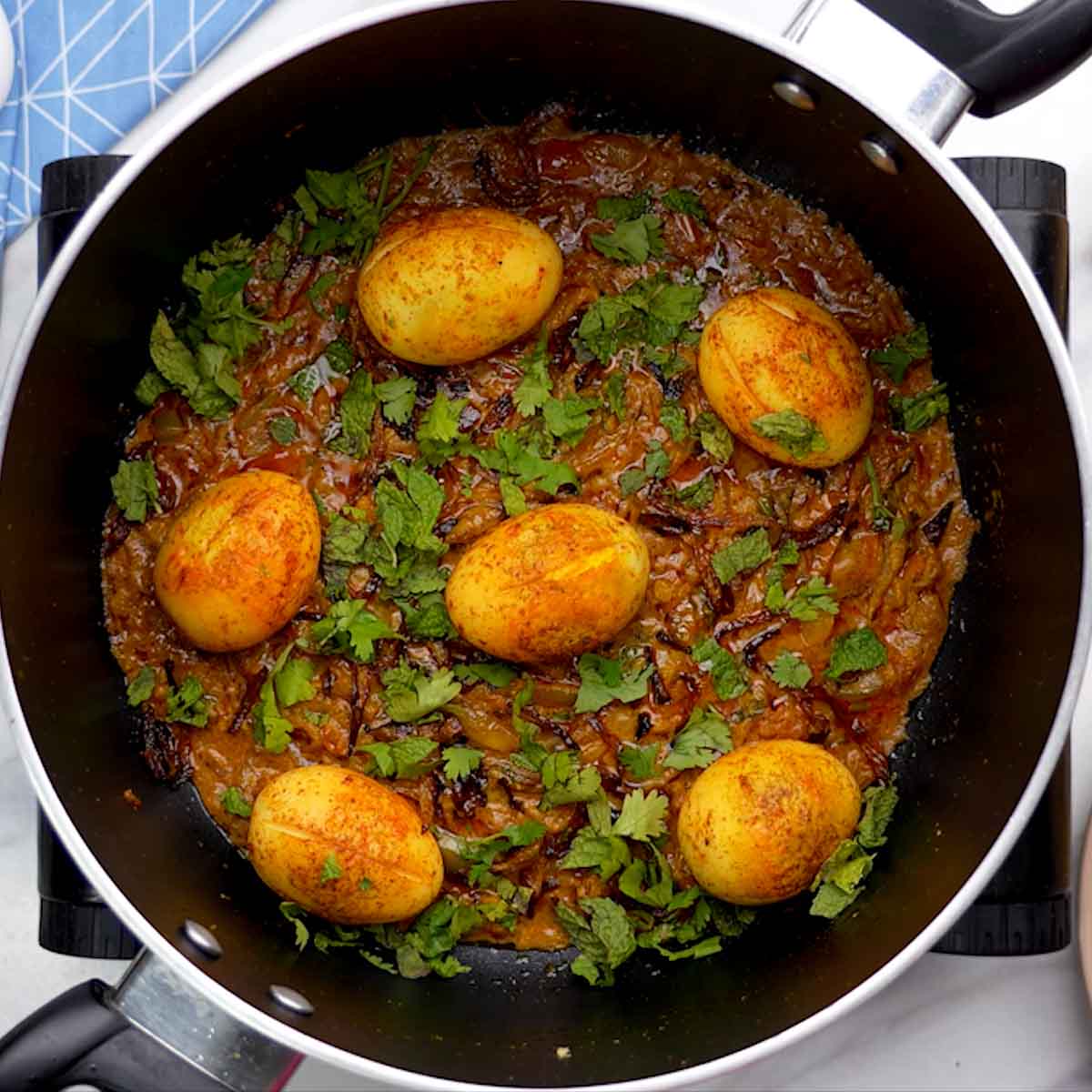 layer the biryani with egg, onion and mint