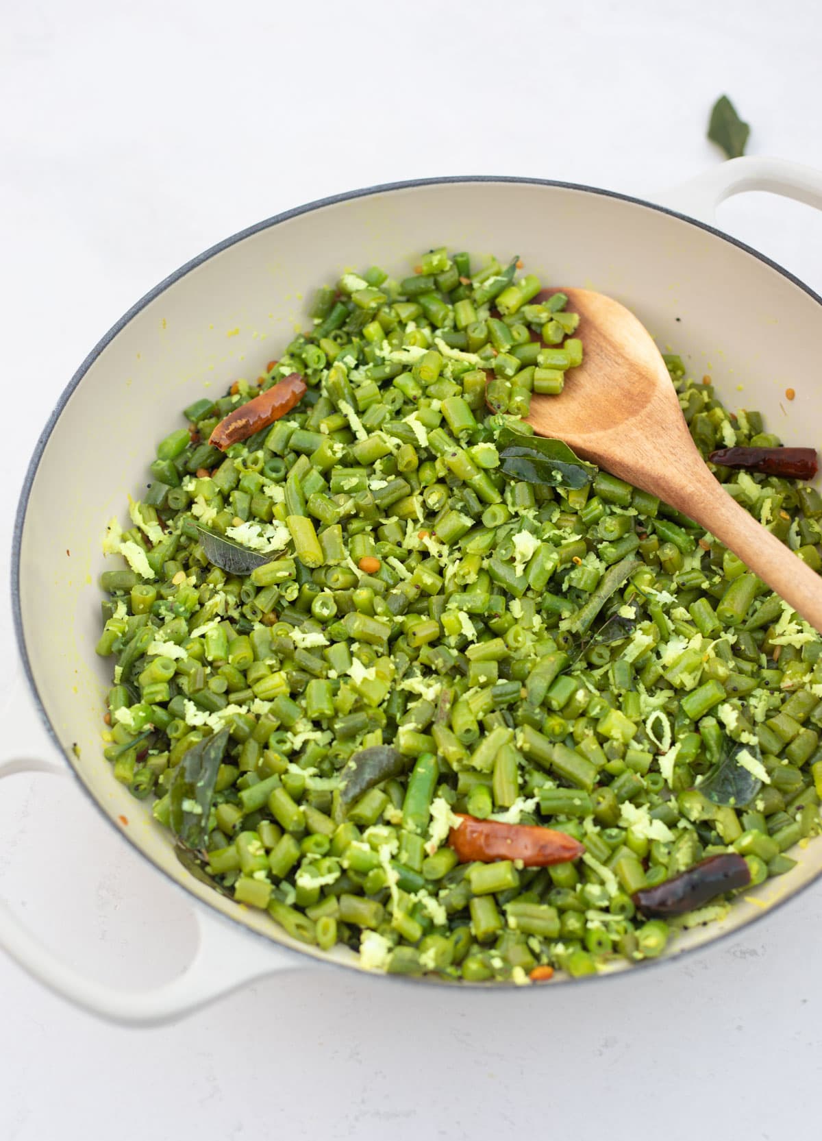 Green Beans Poriyal in a white pan