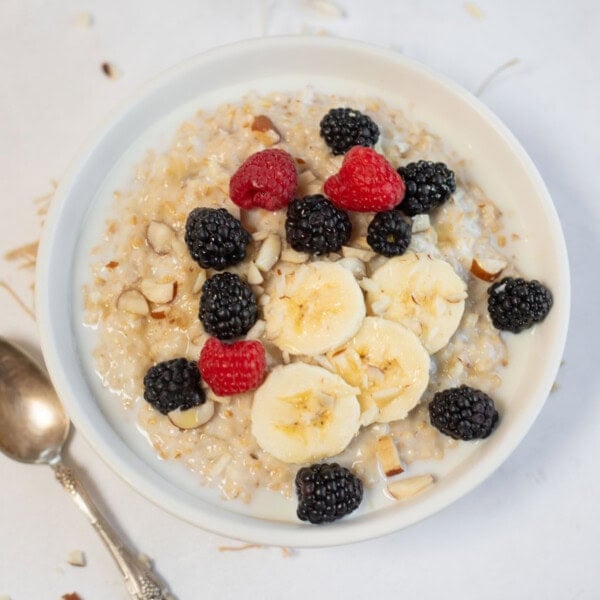 steel cut oats with slices of banana and berries