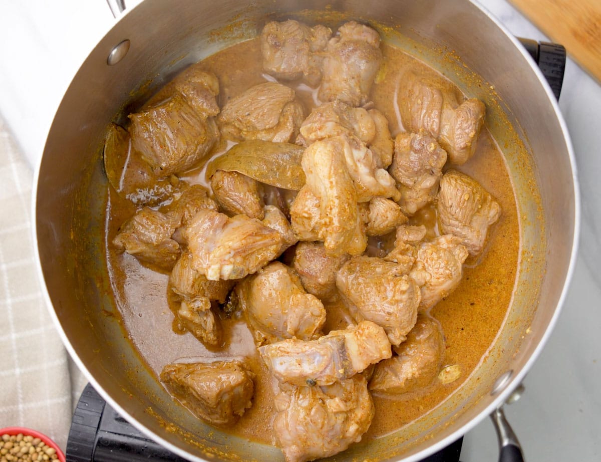 Mutton cooked with yogurt and spices in a pot 