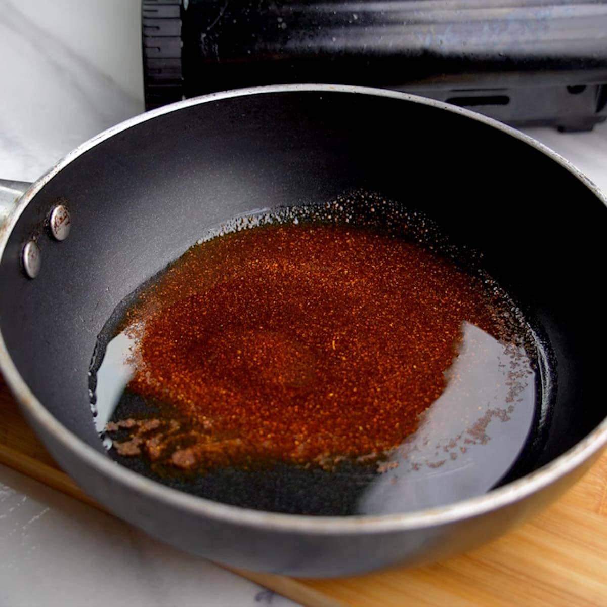 melt ghee and add red chili powder in a pan