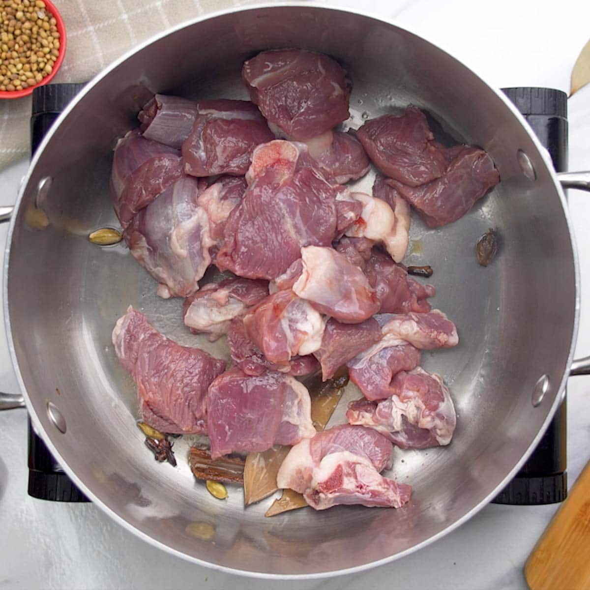 add mutton to a pot to make rogan josh