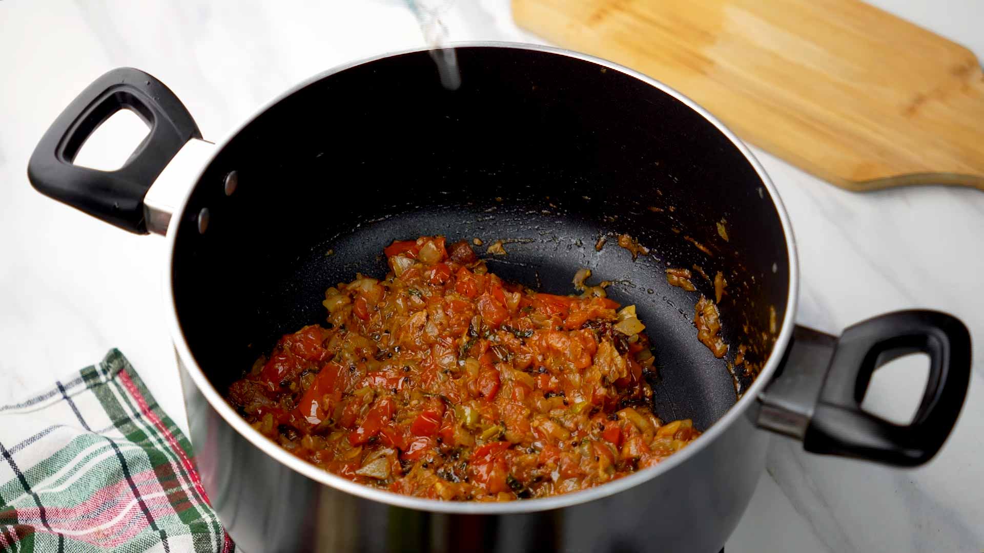 Cook until tomatoes are soft and oil separates.