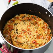 cooked tomato rice in black pot