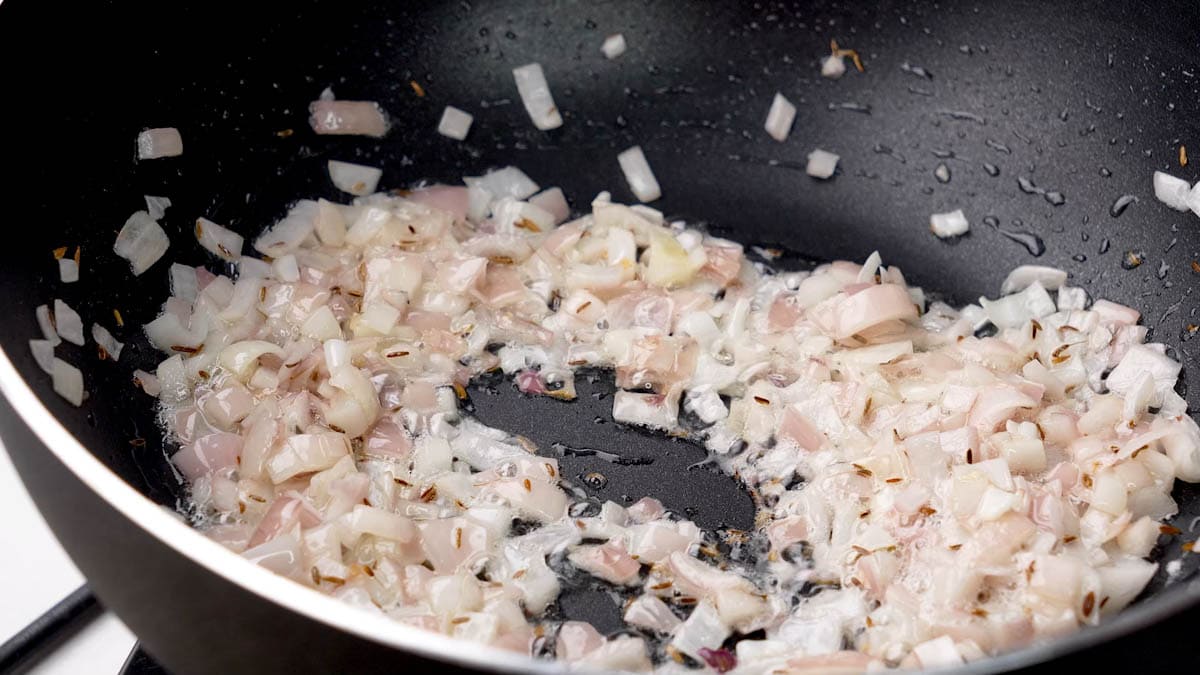 Add finely chopped onion to the pan.