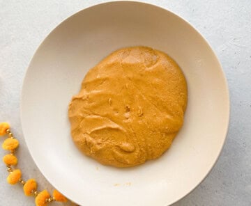 besan ladoo mixture in a white plate