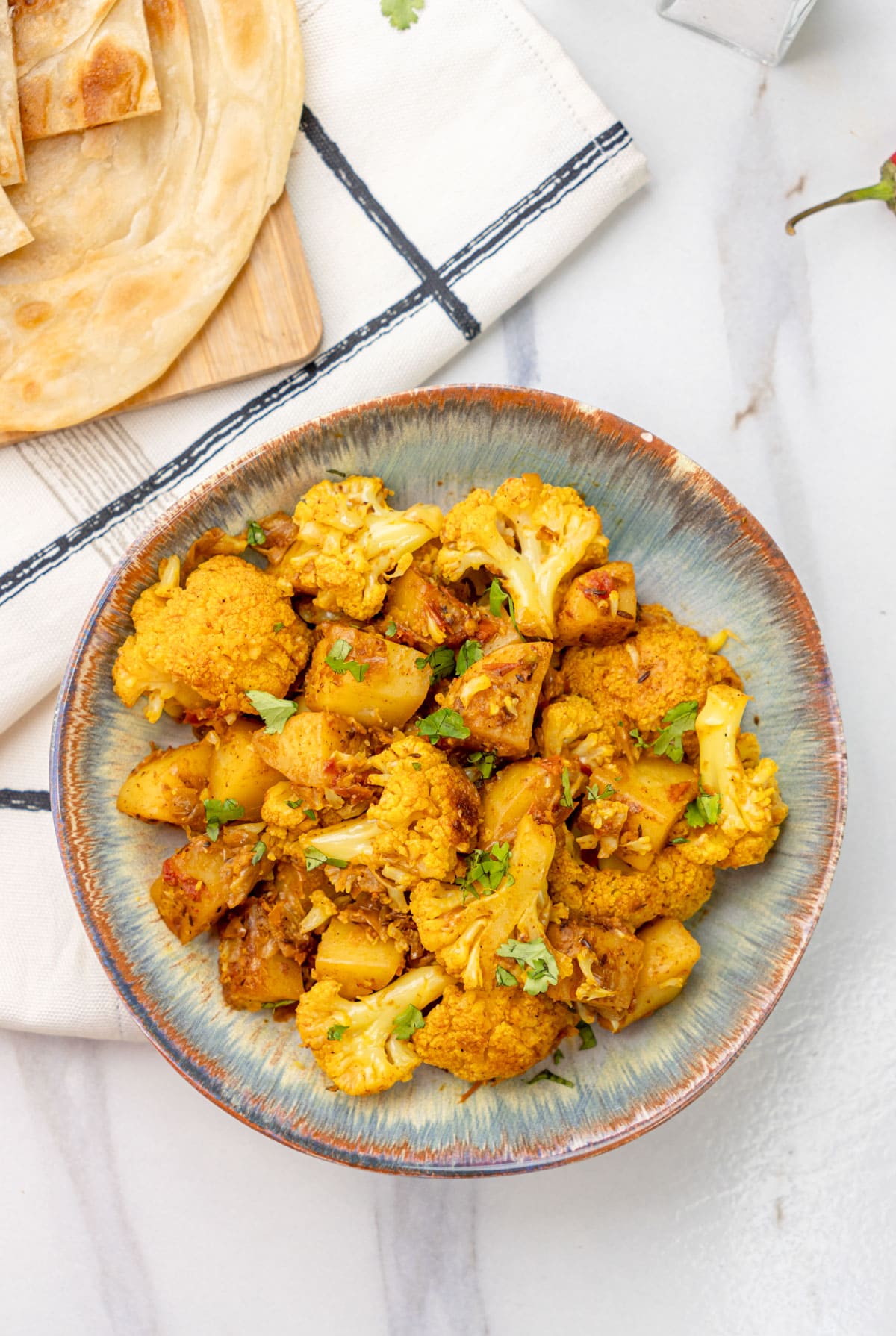 Aloo Gobi stir-fry garnished with cilantro.