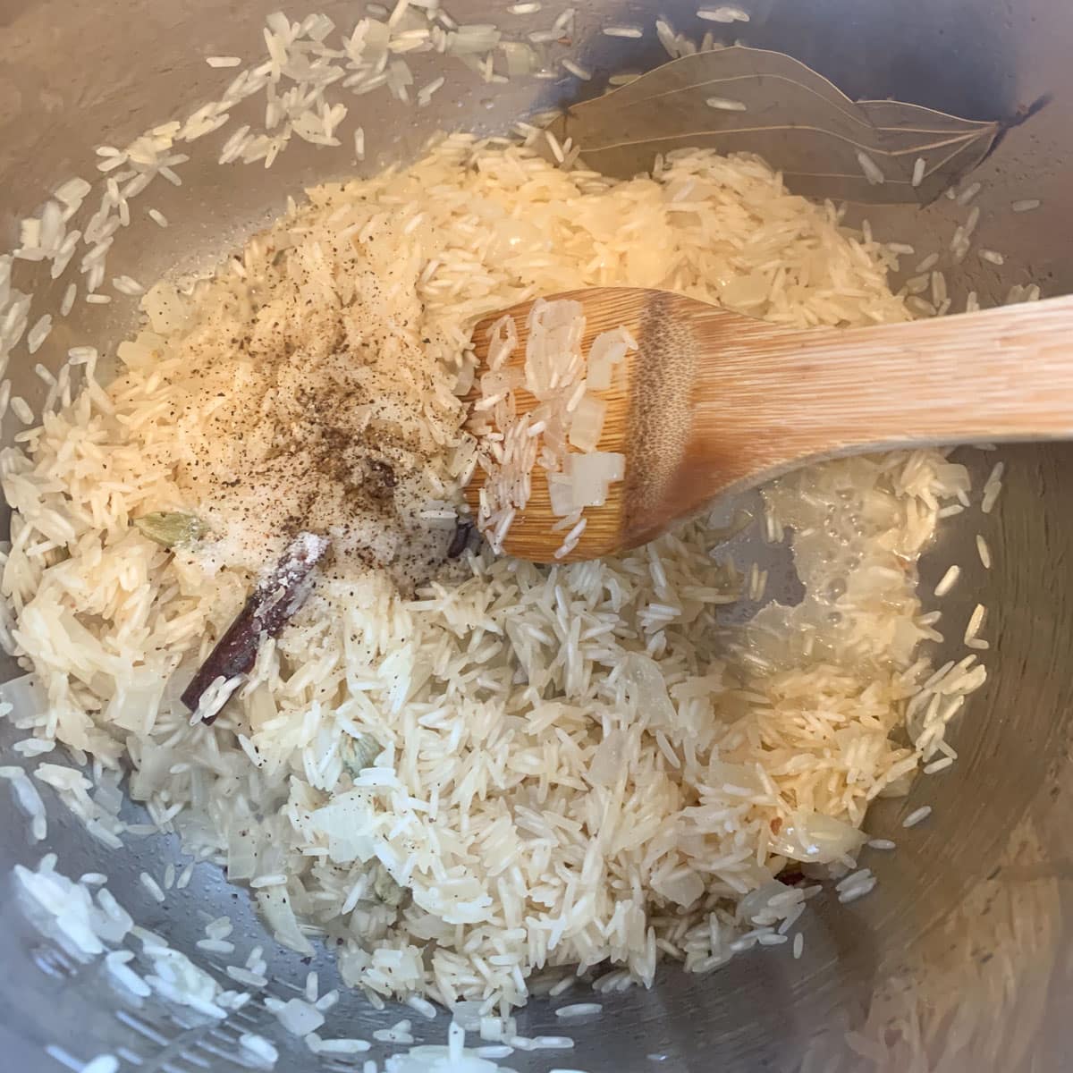 Add the rinsed rice now, for preparing Rice pilaf with nuts and raisins.