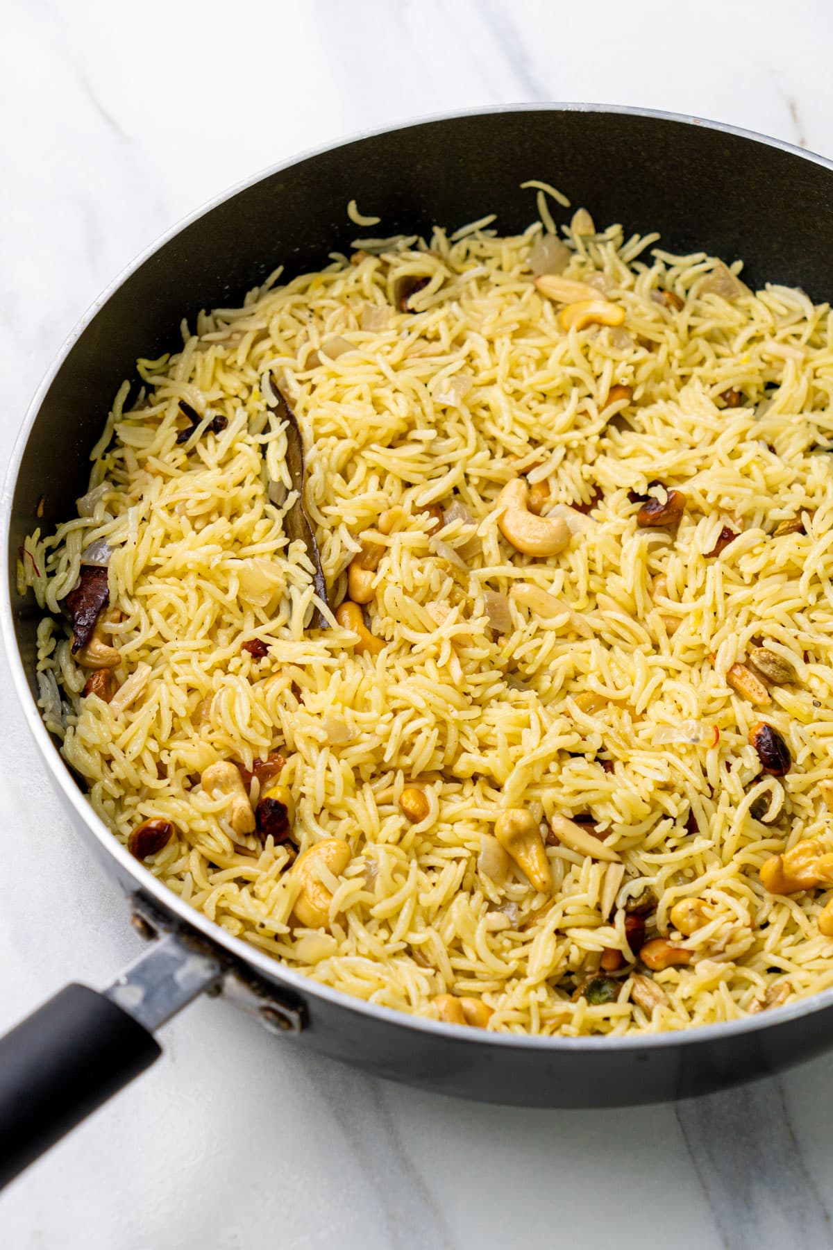 close up shot of saffron rice in a black pan