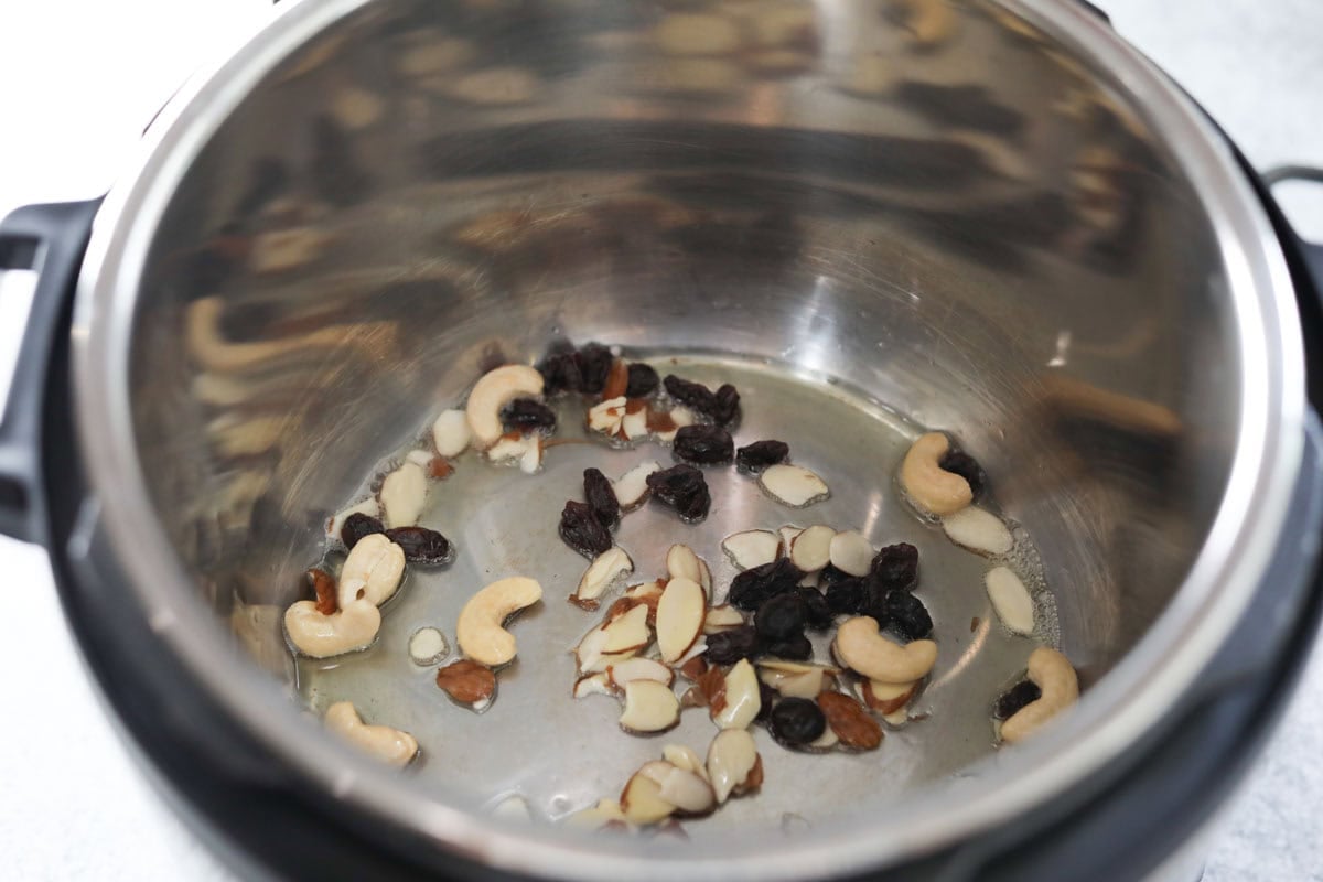 saute cashews, almonds and raisins in instant pot