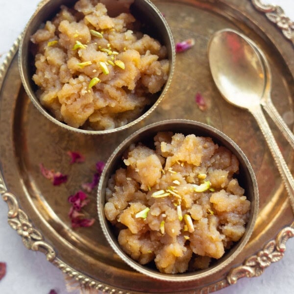 aate ka halwa topped with nuts in a two brass bowl