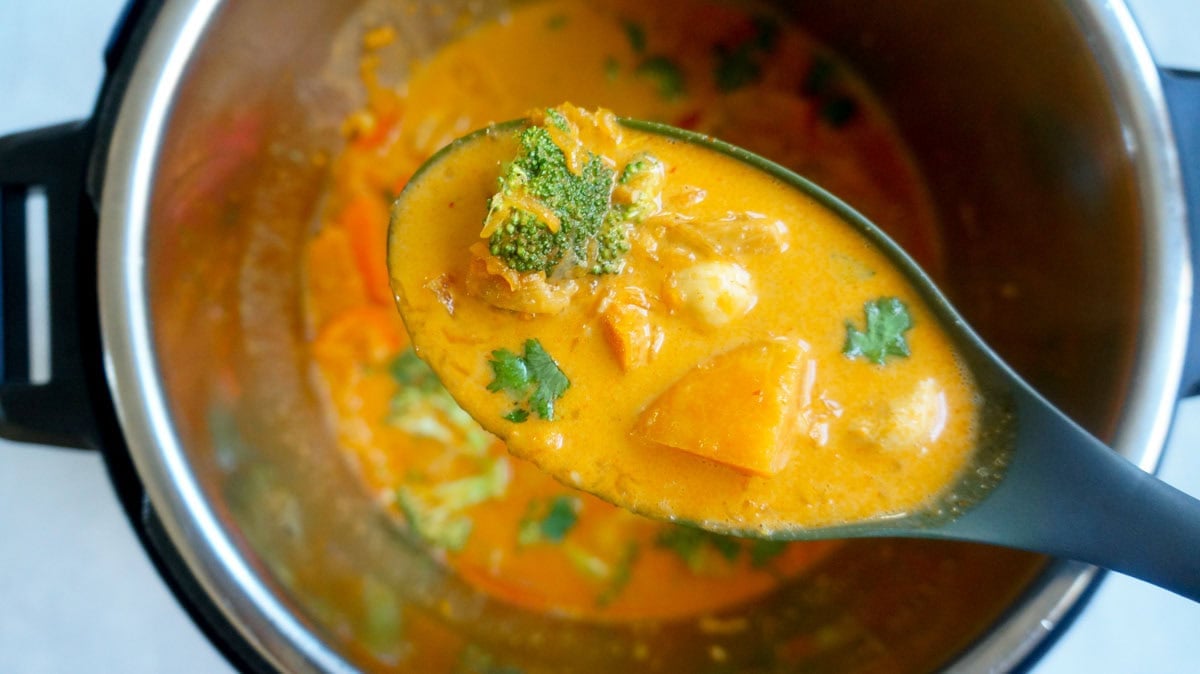 thai pumpkin curry in a ladle over the instant pot