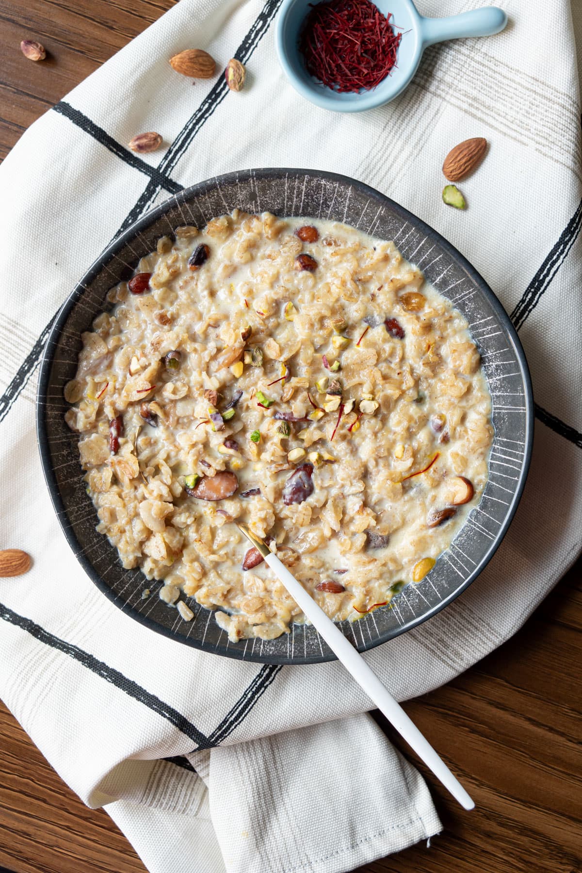 top view of oats kheer in a bowl with spoon