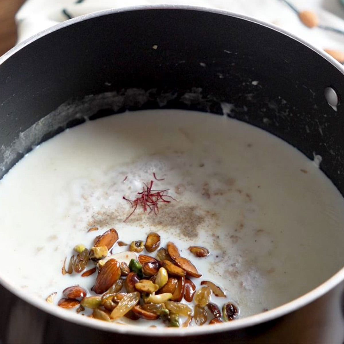 add saffron, cardamom and roasted nuts to make oats kheer