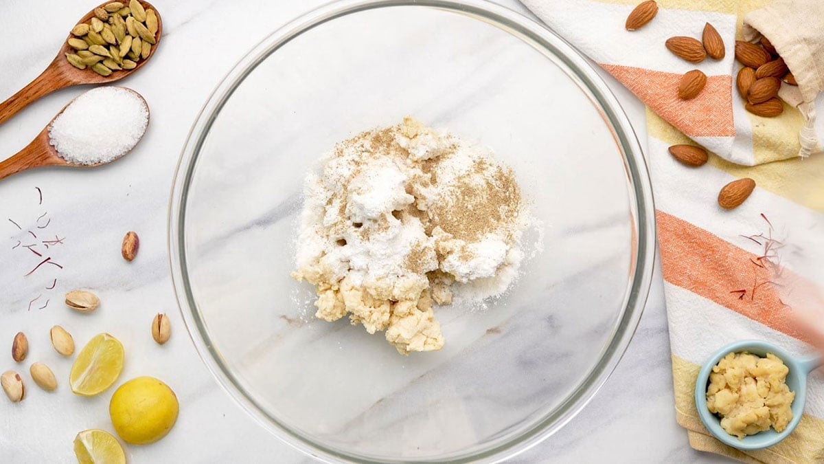 Mix all purpose flour, baking powder and cardamom powder in a bowl