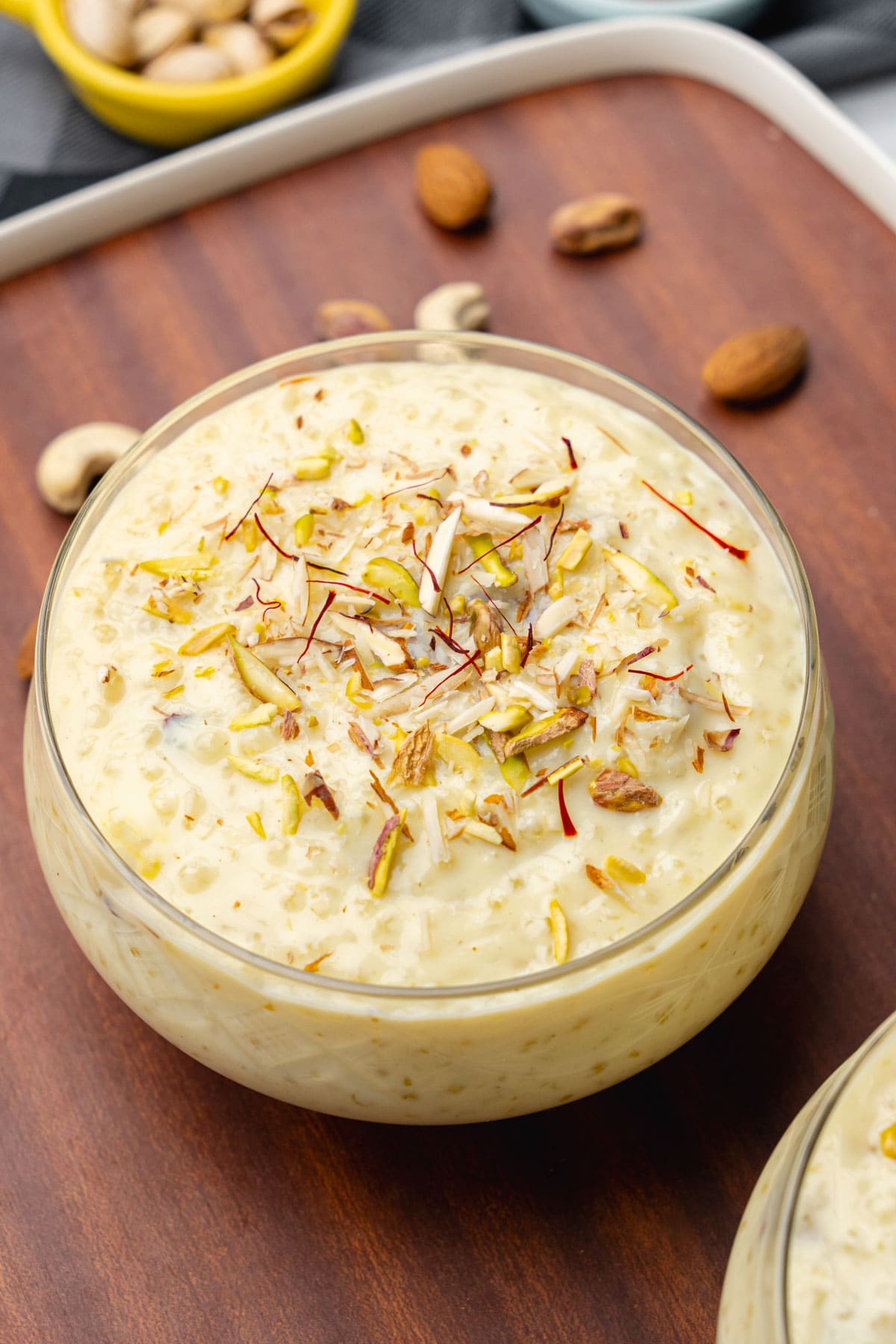 Sabudana kheer in a bowl garnished with nuts and saffron