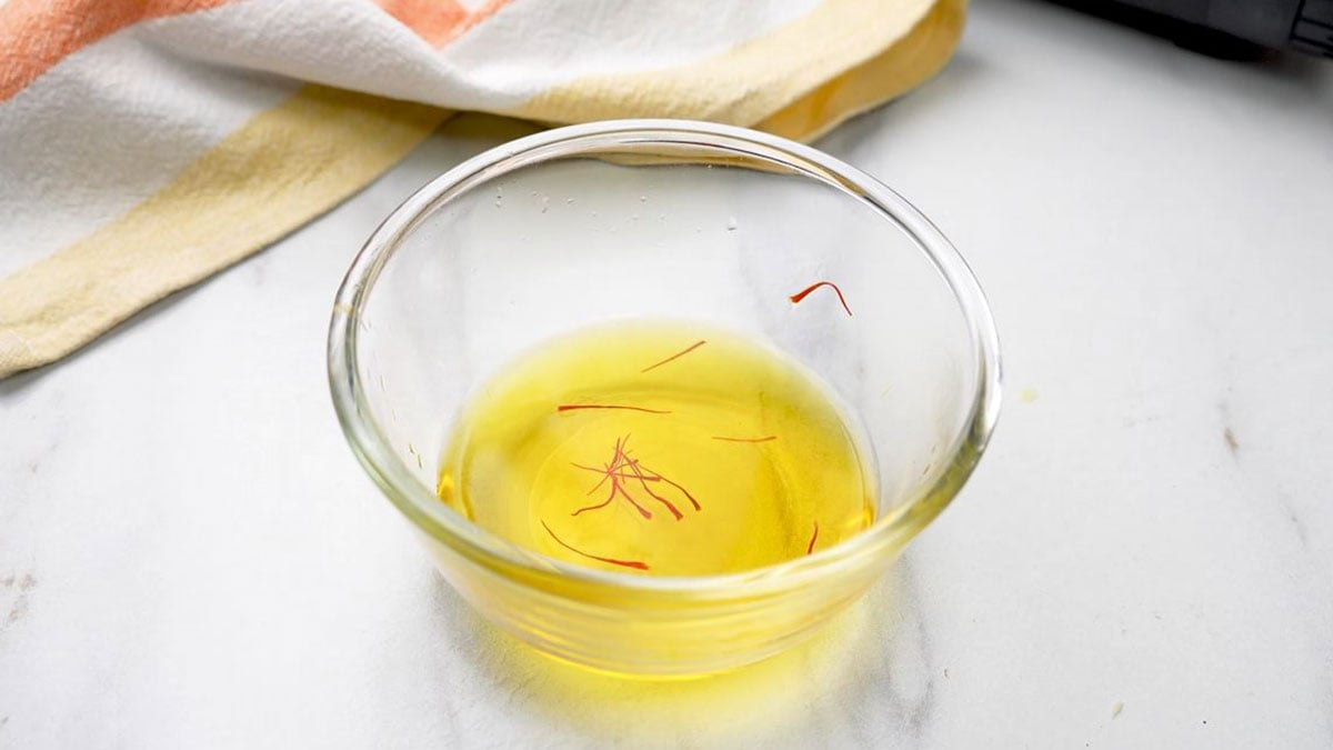 saffron soaked in water in a small bowl