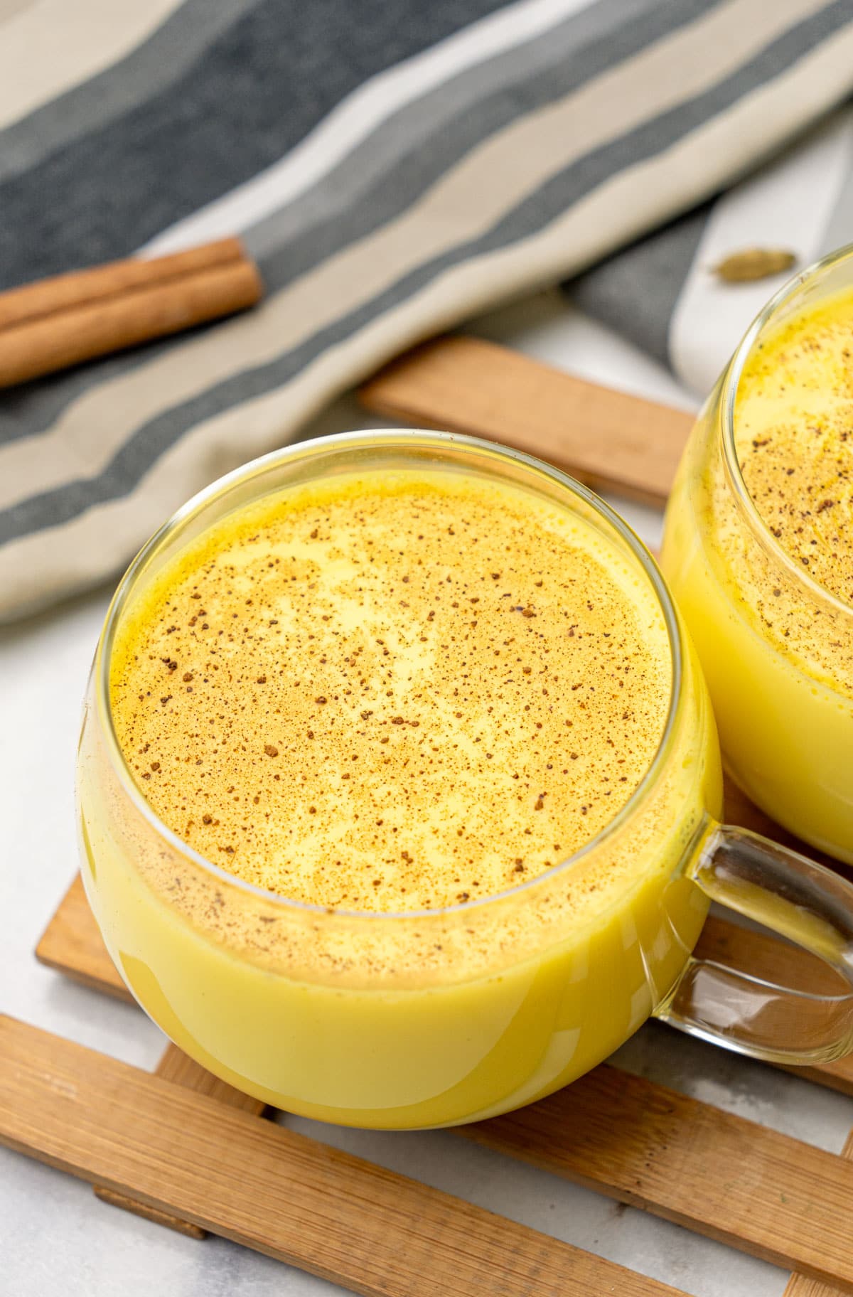 closeup shot of Golden Turmeric Milk in two glass cup