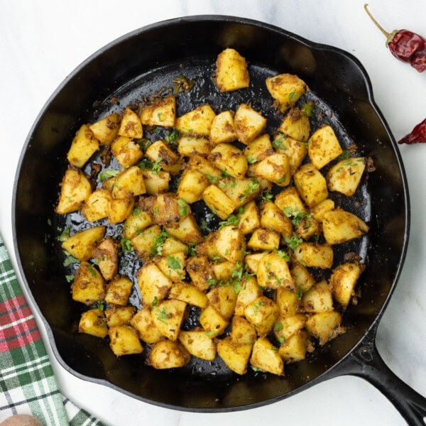 top view of jeera aloo in a cast iron