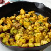 Jeera aloo in a pan garnished with cilantro